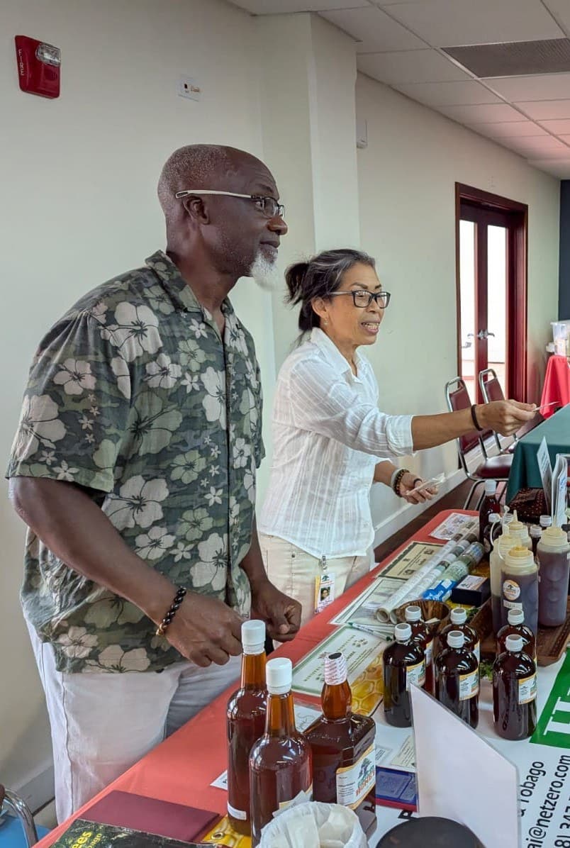 Dereck and Jo Lee Herbert of HerbWai Honey at a HerbWai stall with bottles of their honey